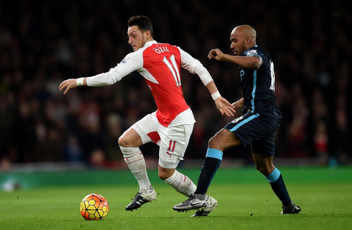 Ozil knocks the ball past Delph