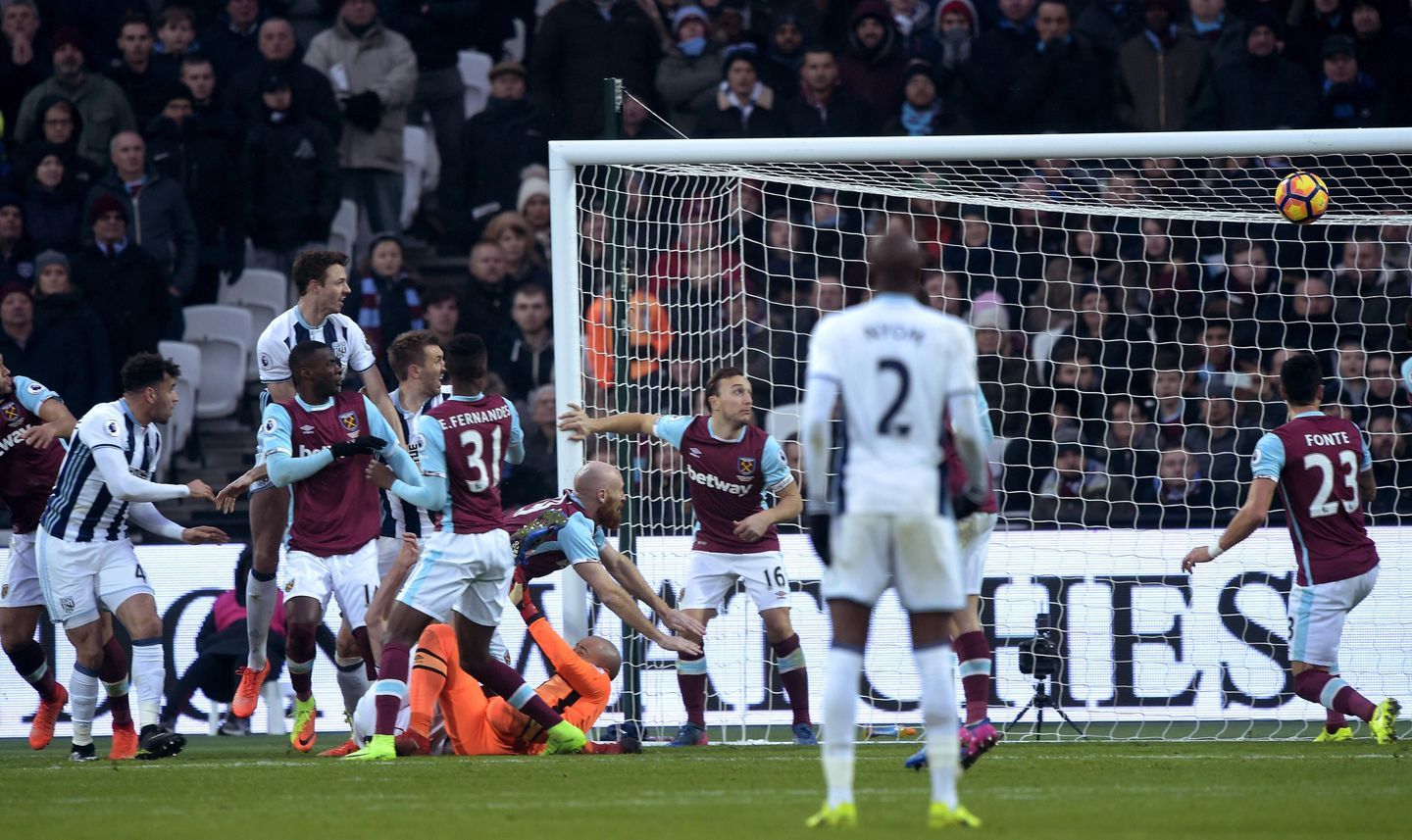 Jonny Evans and Gareth McAuley go for goal