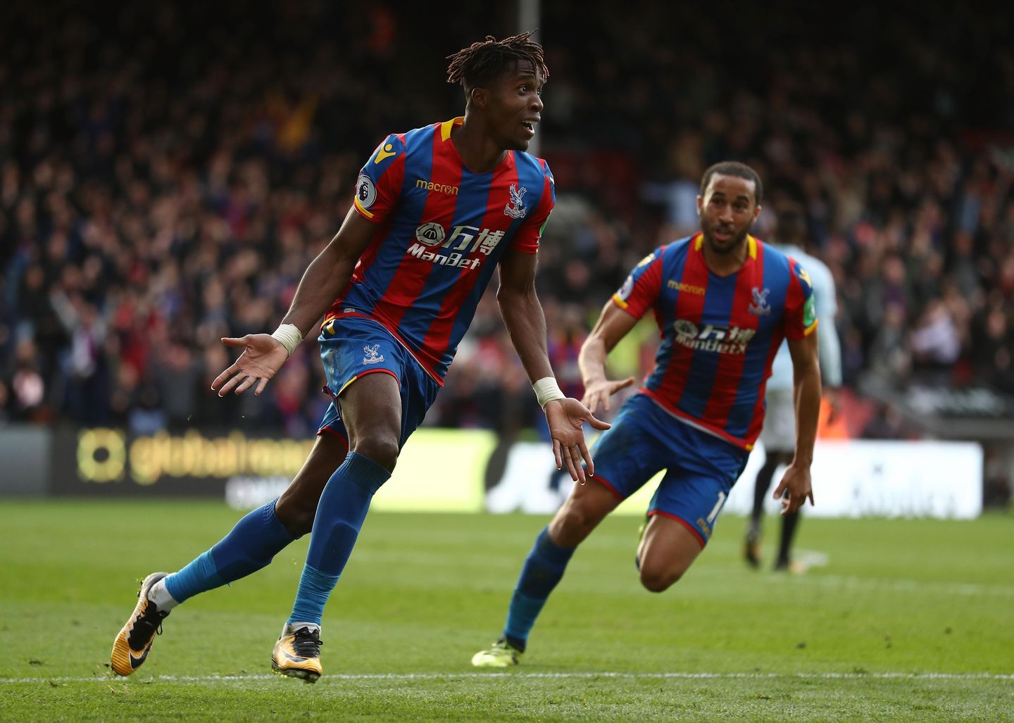 Wilfried Zaha and Andros Townsend celebrate the late equaliser against West Ham