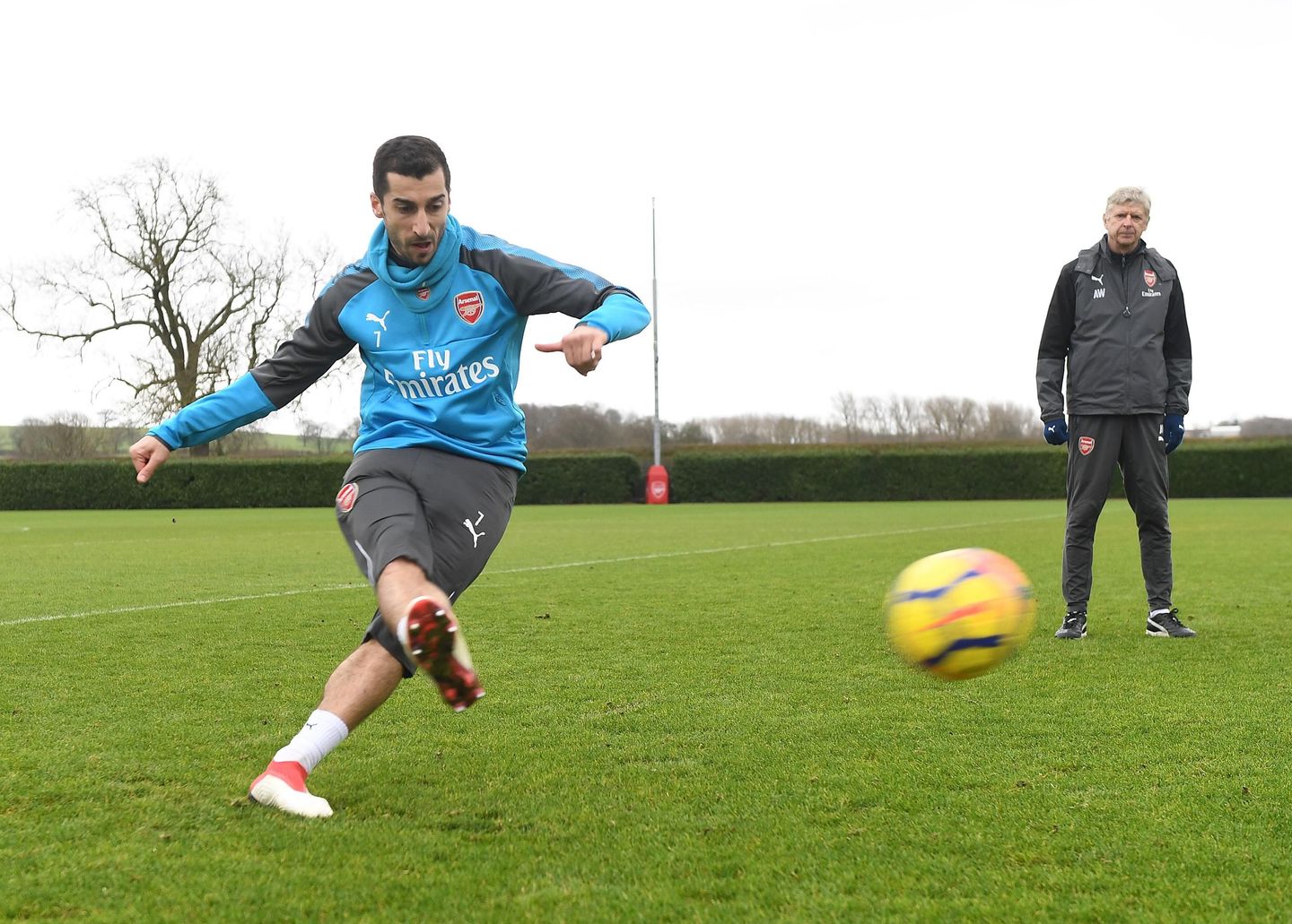 Henrikh Mkhitaryan in training, watched by Arsene Wenger