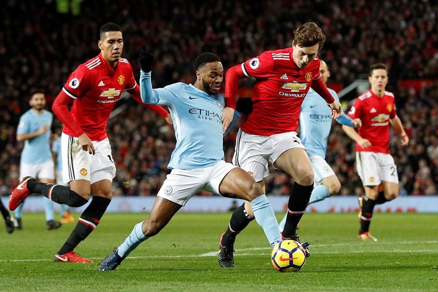 Raheem Sterling in action against Man Utd's Chris Smalling and Victor Lindelof