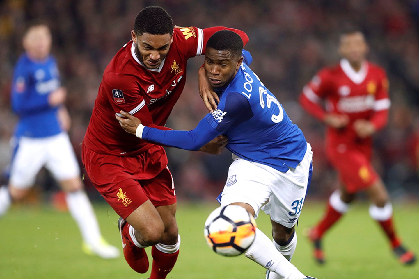 Joe Gomez and Ademola Lookman compete for the ball in the Merseyside derby