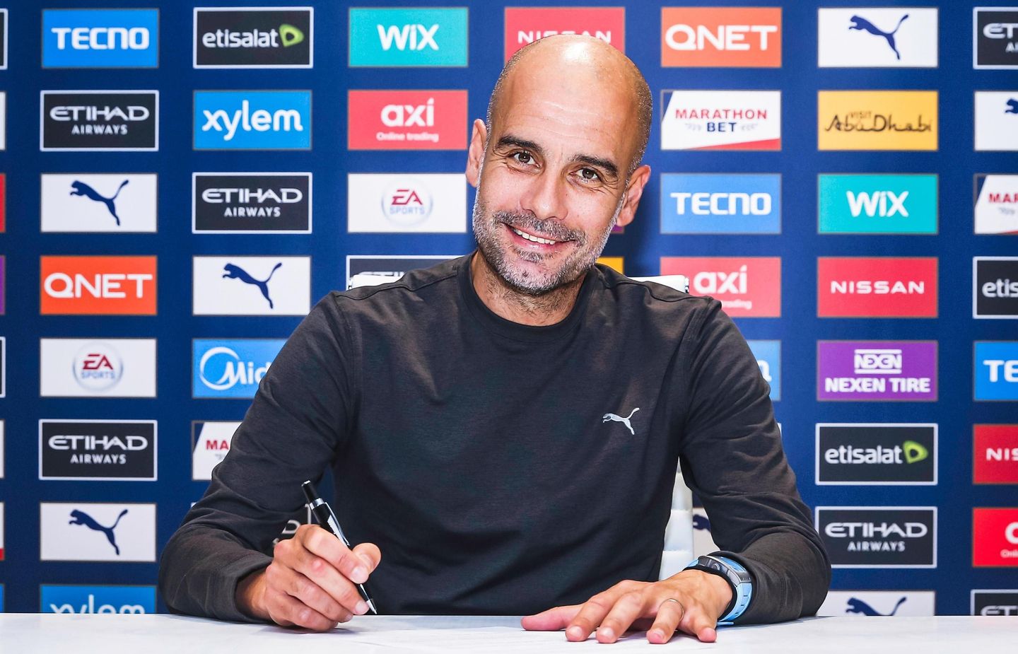 Pep Guardiola signs new contract