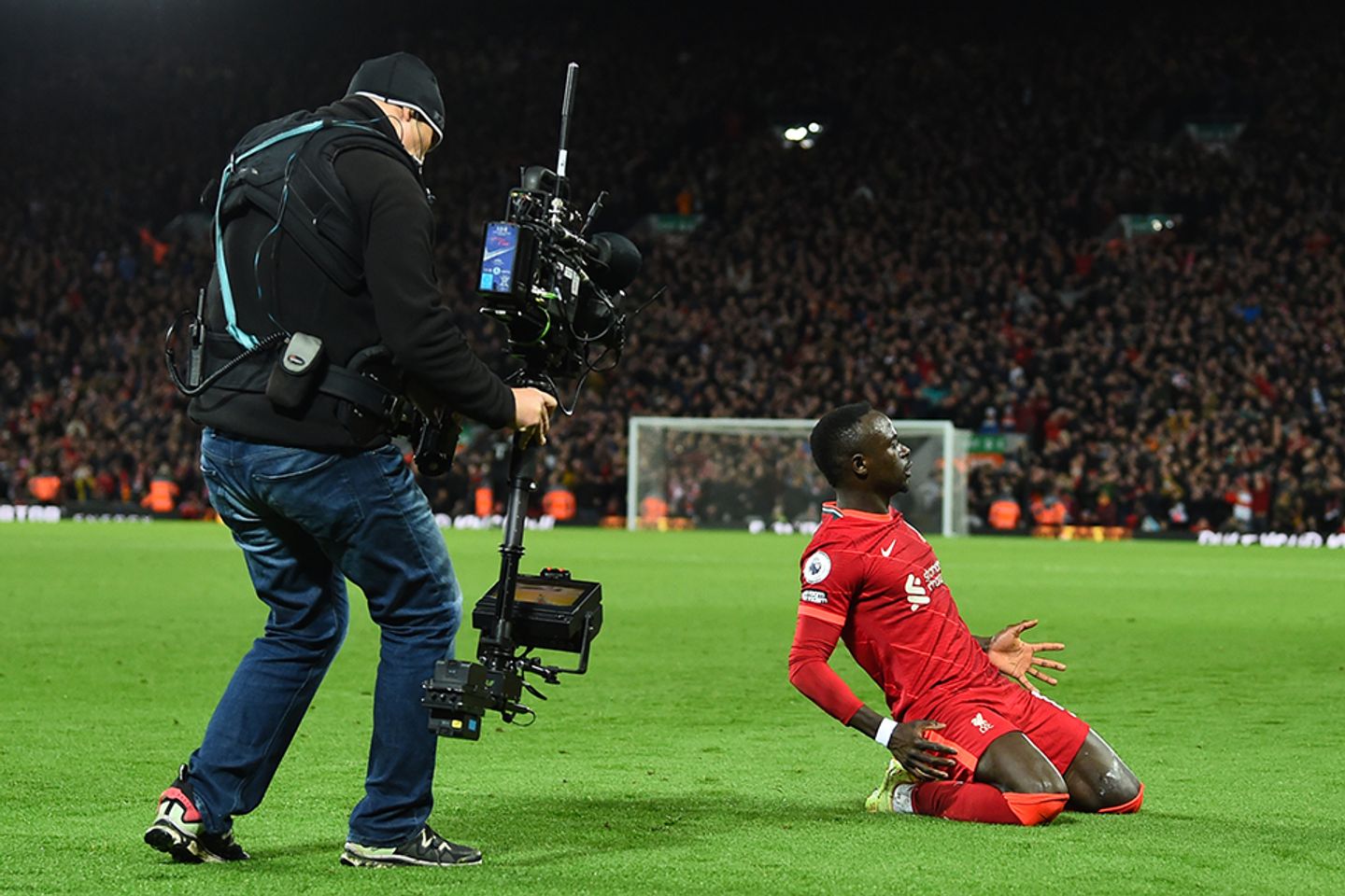 A cameraman captures Sadio Mane sliding in celebration