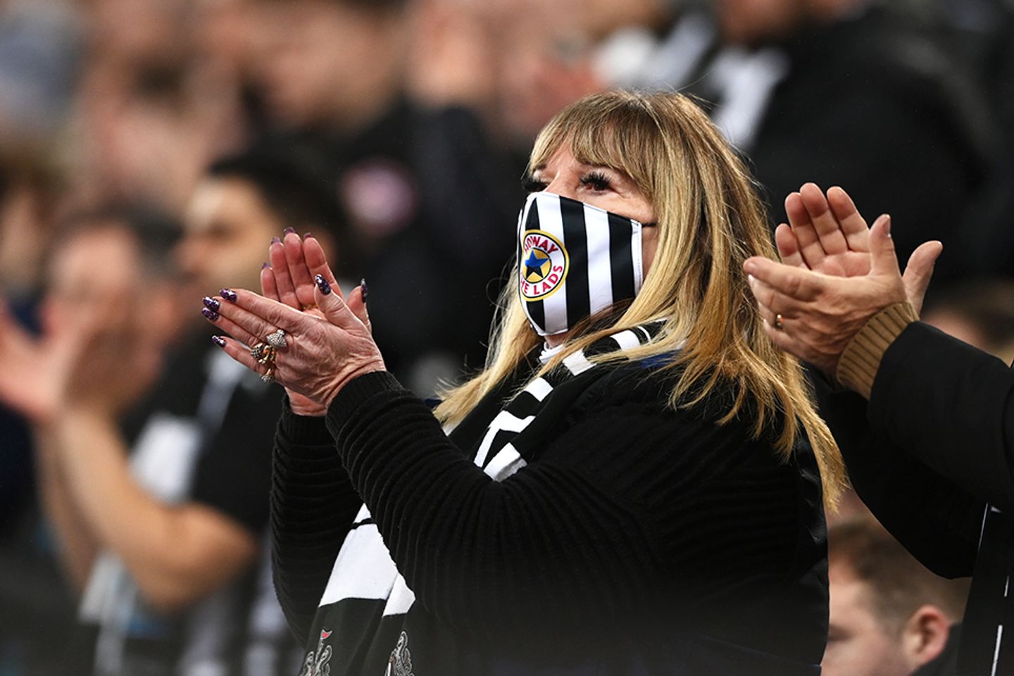 Newcastle fan wearing a mask