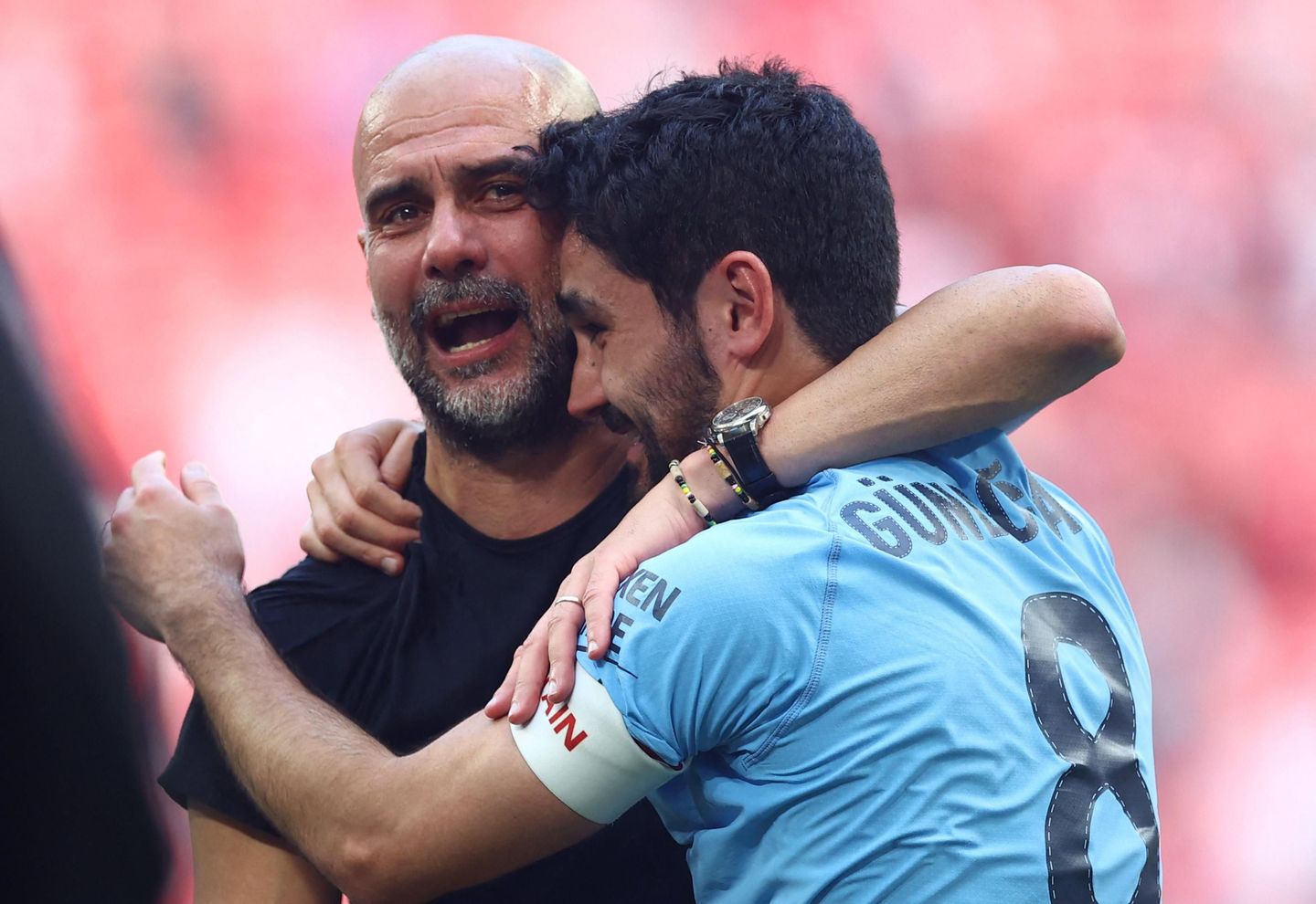 Ilkay Gundogan embraces Pep Guardiola after the FA Cup final 2