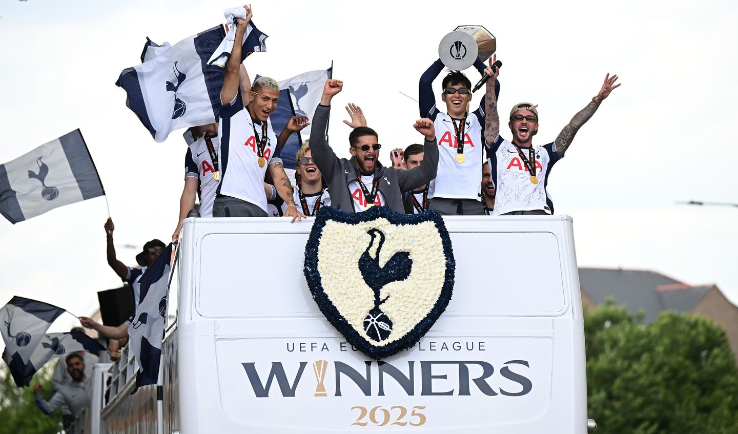 Son holds the trophy aloft surrounded by jubilant team-mates
