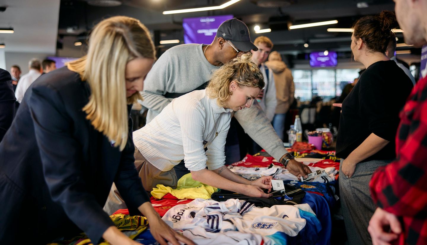 Conference attendendees take a close look at genuine and fake football shirts