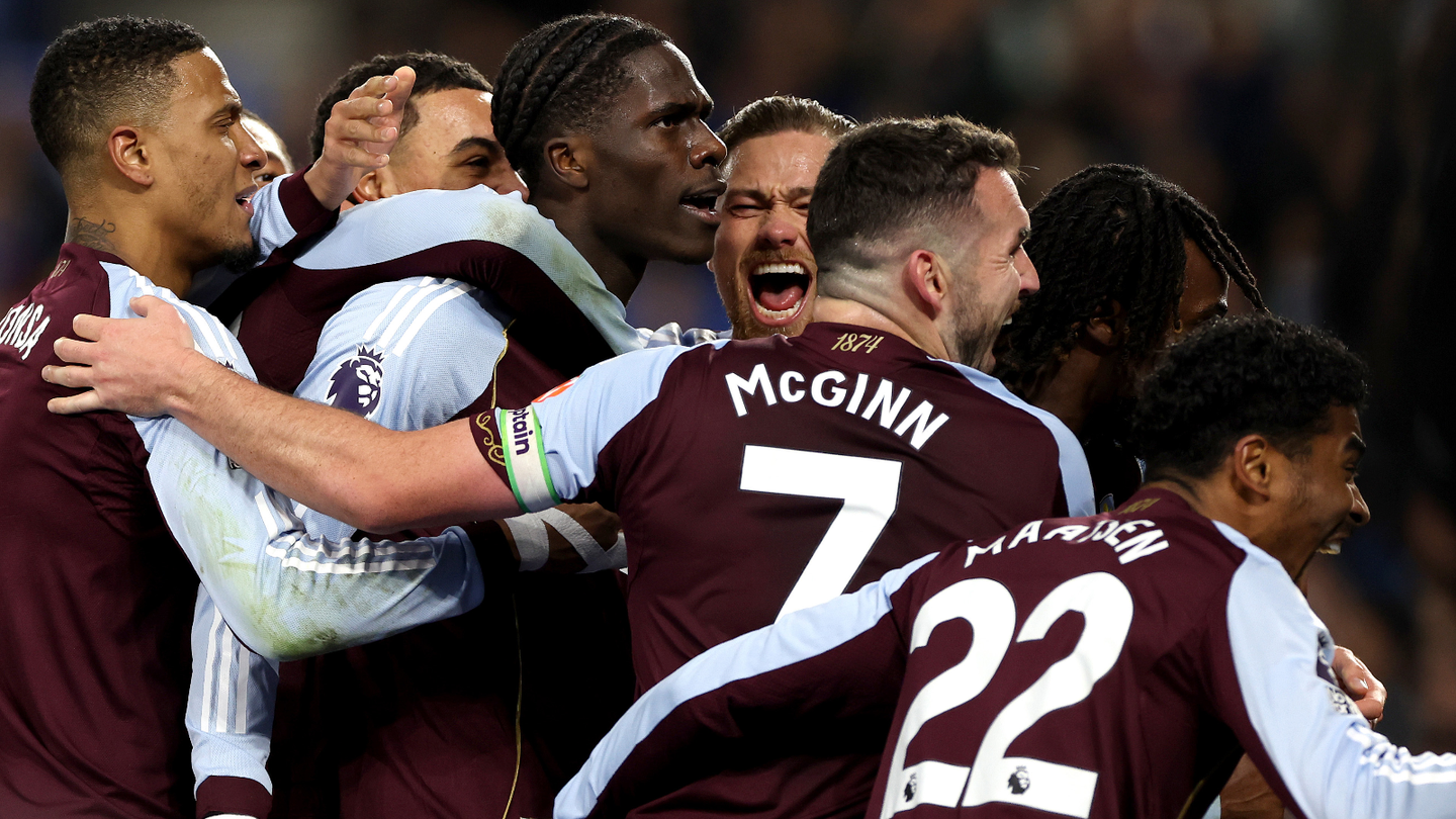 Ecstatic Aston Villa players celebrate with the scorer of their third goal at Brighton, Amadou Onana