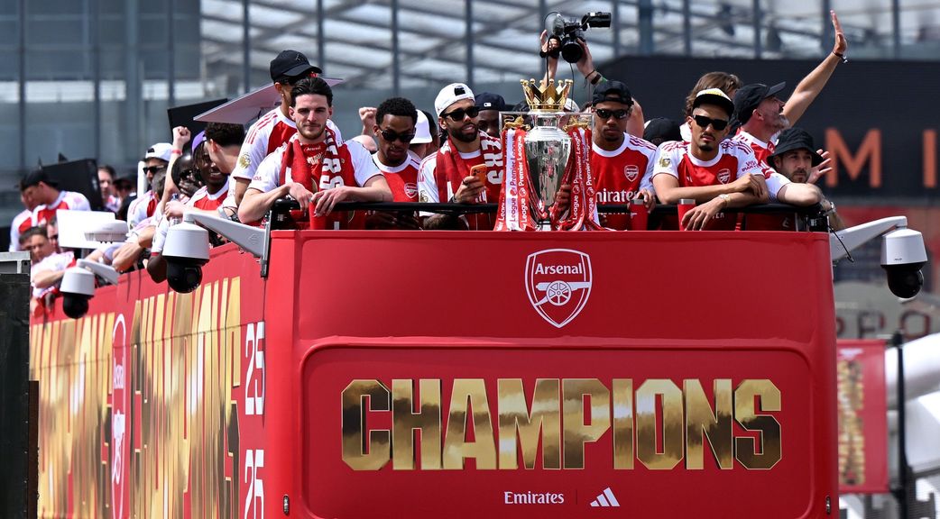 Declan Rice and Arsenal teammates celebrating with the Premier League Trophy