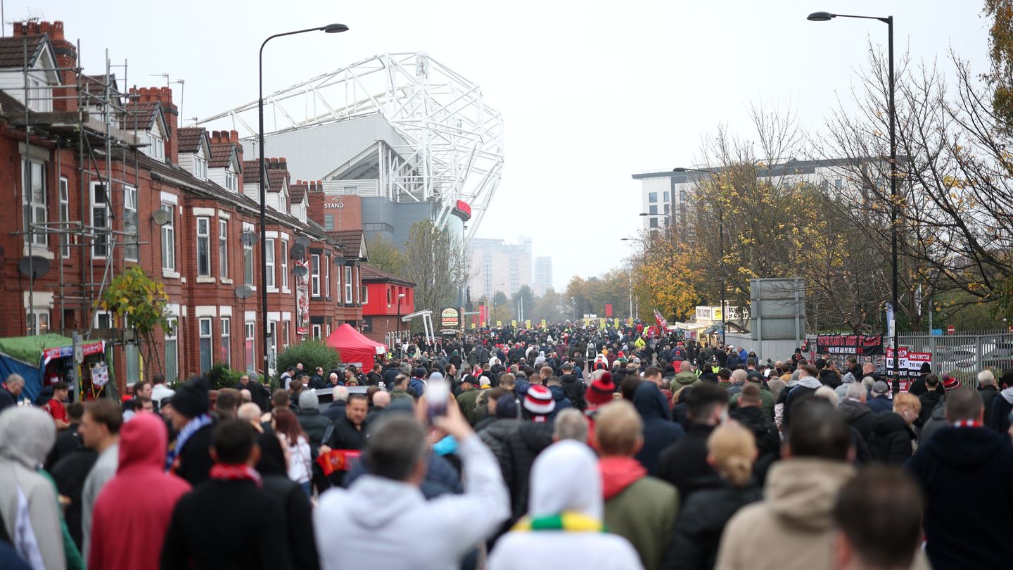 Fans arrive at Manchester United's Old Trafford stadium