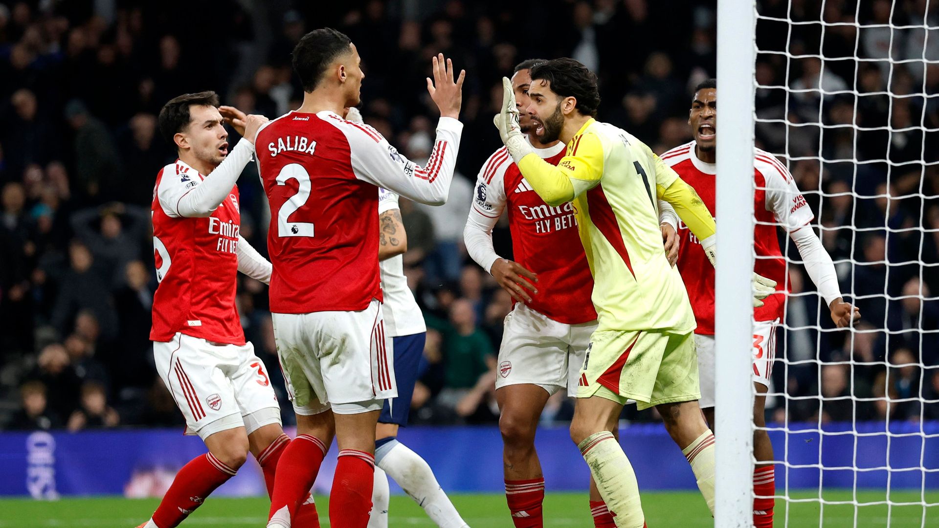 Arsenal players congratulate David Raya for an important save